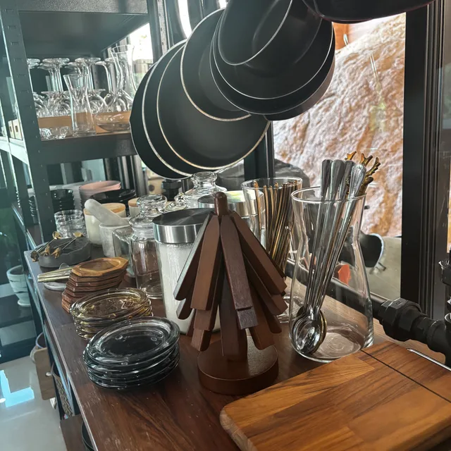 Bar counter with glassware, pendant lamps and wooden serving boards